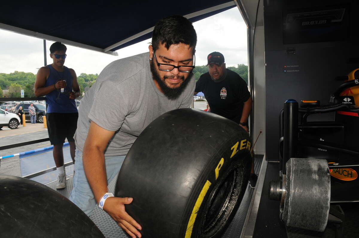 Manuel Gaspar pulls the old tire off as he competes during the Red Bull Pit Stop Challenge on Saturday in Collinsville.