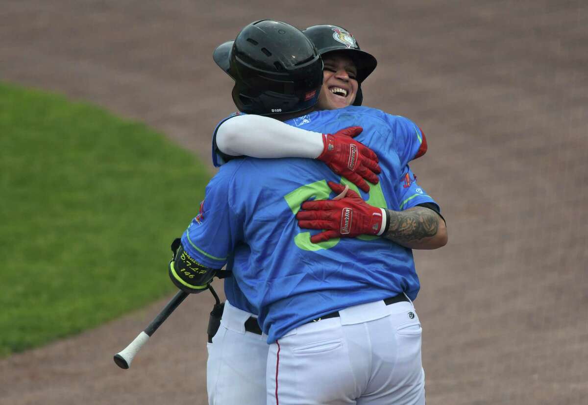 Daniel Angulo of the ValleyCats, right, gets a hug from a teammate after Angulo hit a home run to give the ValleyCats the lead during their game against the Quebec Capitales on Sunday, June 12, 2022, in Troy, N.Y. (Paul Buckowski/Times Union)