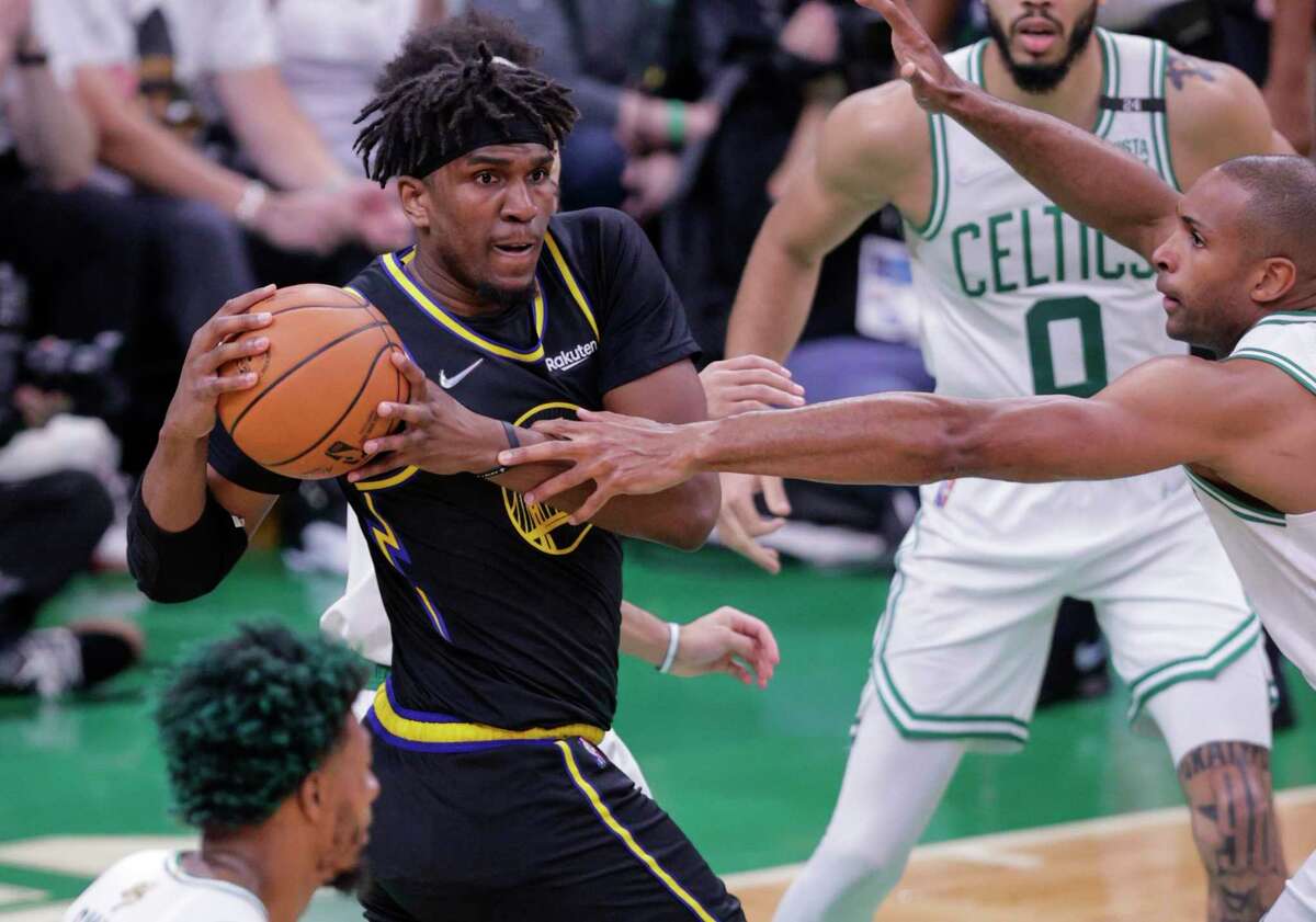 Golden State Warriors' Kevon Looney, 5, pulls down a rebound during the first quarter in Game 4 of the NBA Finals at TD Garden in Boston, Mass., on Friday, June 10, 2022.