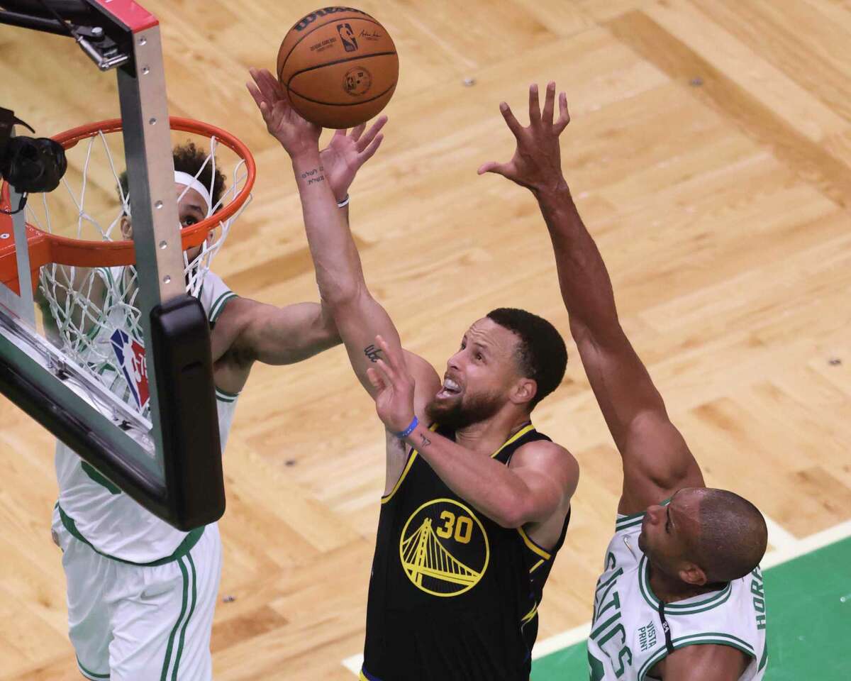 Golden State Warriors' Stephen Curry, 30, attempts a shot over Boston Celtics' Al Horford, 42, during the second quarter in Game 4 of the NBA Finals at TD Garden in Boston, Mass., on Friday, June 10, 2022.