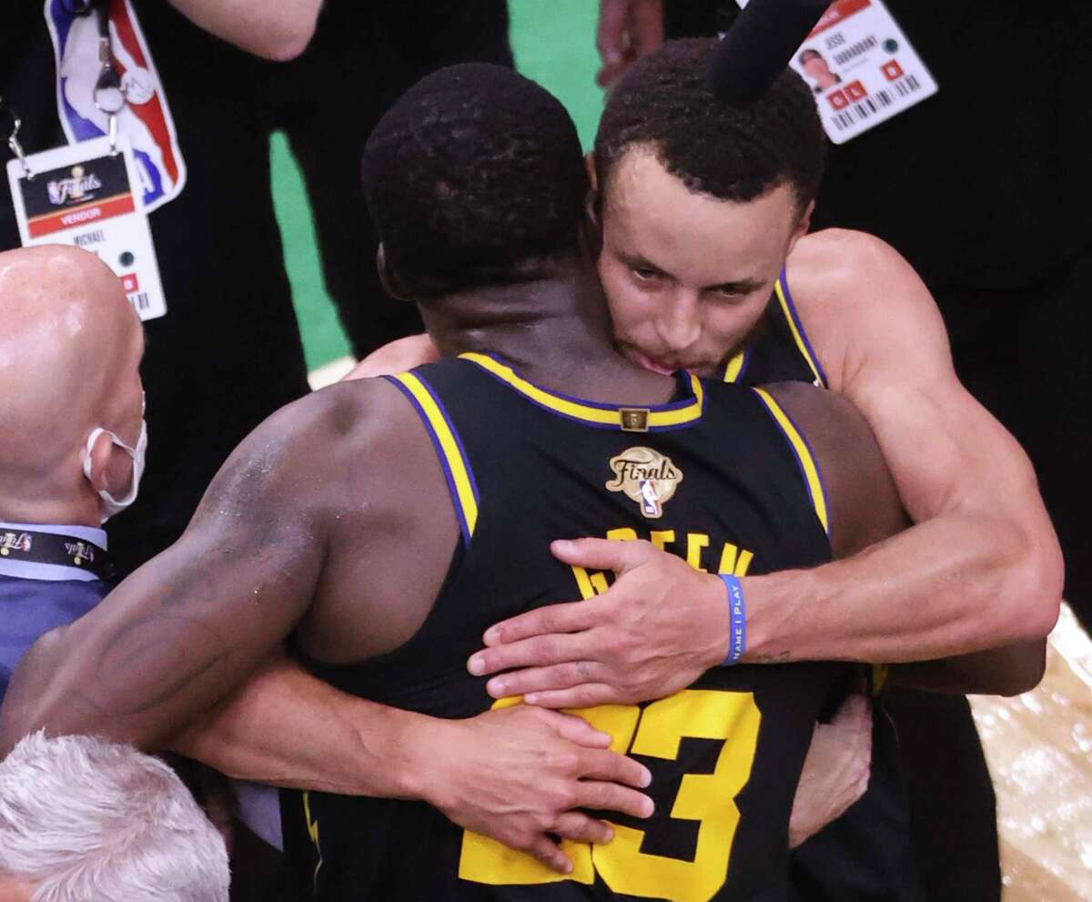 Golden State Warriors' Stephen Curry, 30, hugs Draymond Green, 23, after defeating the Boston Celtics 107 to 97 in Game 4 of the NBA Finals at TD Garden in Boston, Mass., on Friday, June 10, 2022.