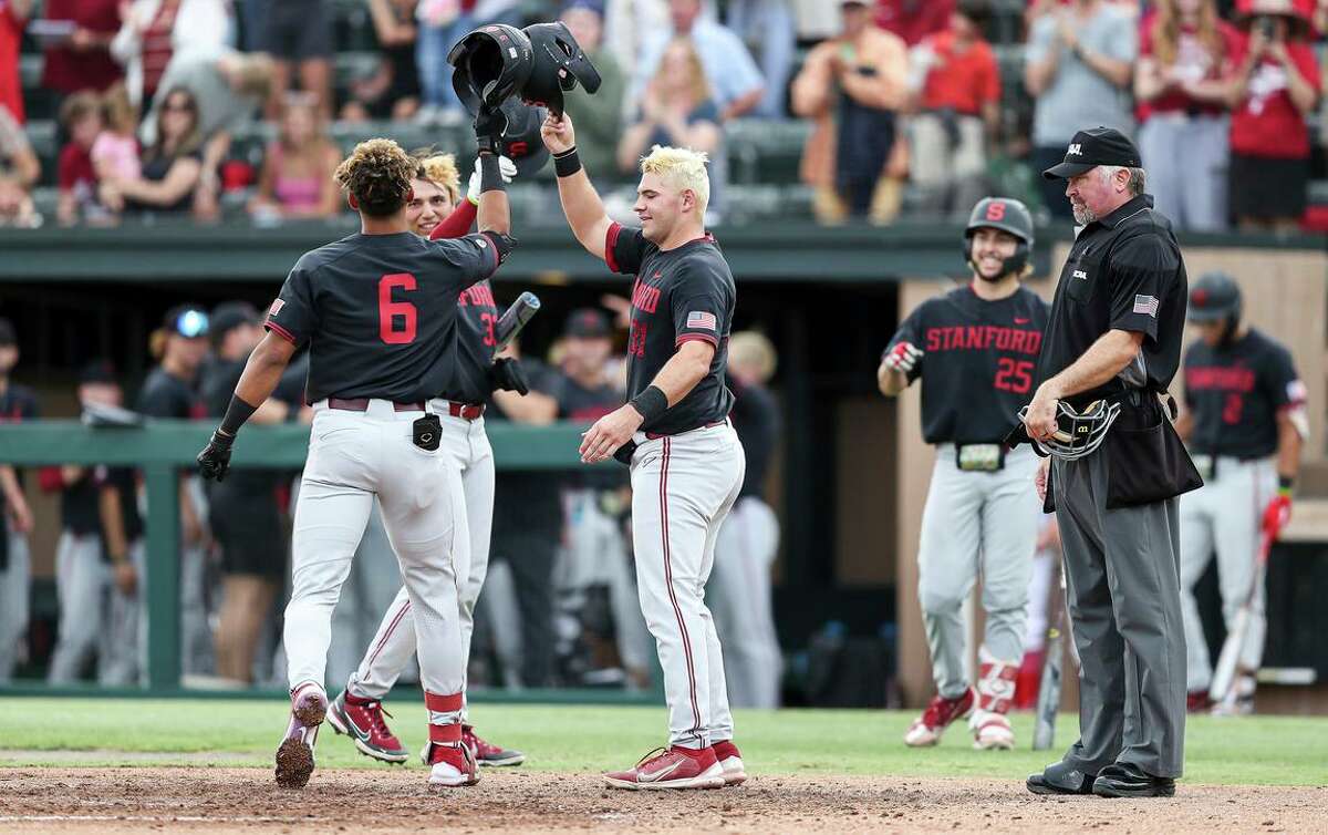 Stanford's Braden Montgomery (6) celebrates with Carter Graham, right, and Brett Barrera after hitting a three-run home run against Connecticut during an NCAA college baseball super regional game Sunday, June 12, 2022, in Stanford, Calif. (AP Photo/Kavin Mistry)