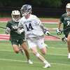 Wilton's Spencer Liston (14) carries the ball with Notre Dame-West Haven's Evan Goldberg (1) and Dominic Dowd (3) in pursuit during the CIAC Class M boys lacrosse final at Sacred Heart University on Sunday, June 12, 2022.