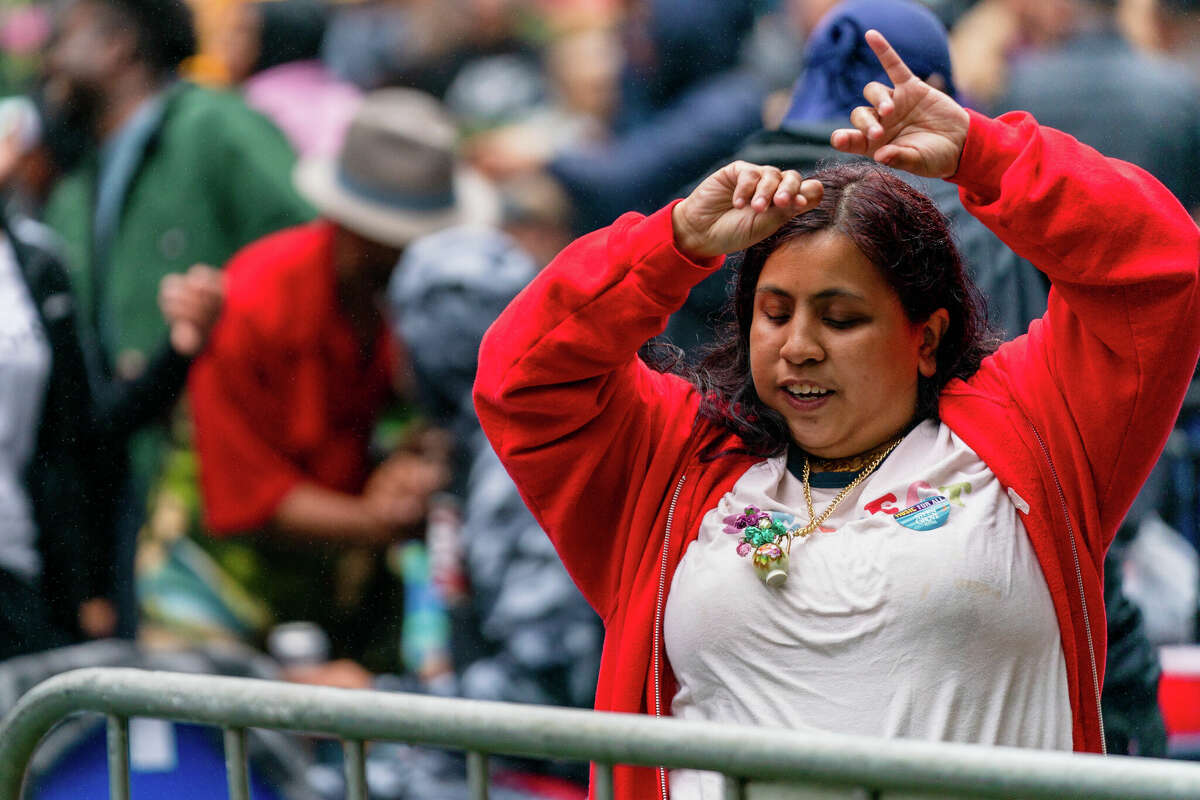 A woman enjoys the music of DJ Shortkut before the start of the show during the first concert of the year at the 85th Stern Grove Festival in San Francisco on Sunday, June 12, 2022.