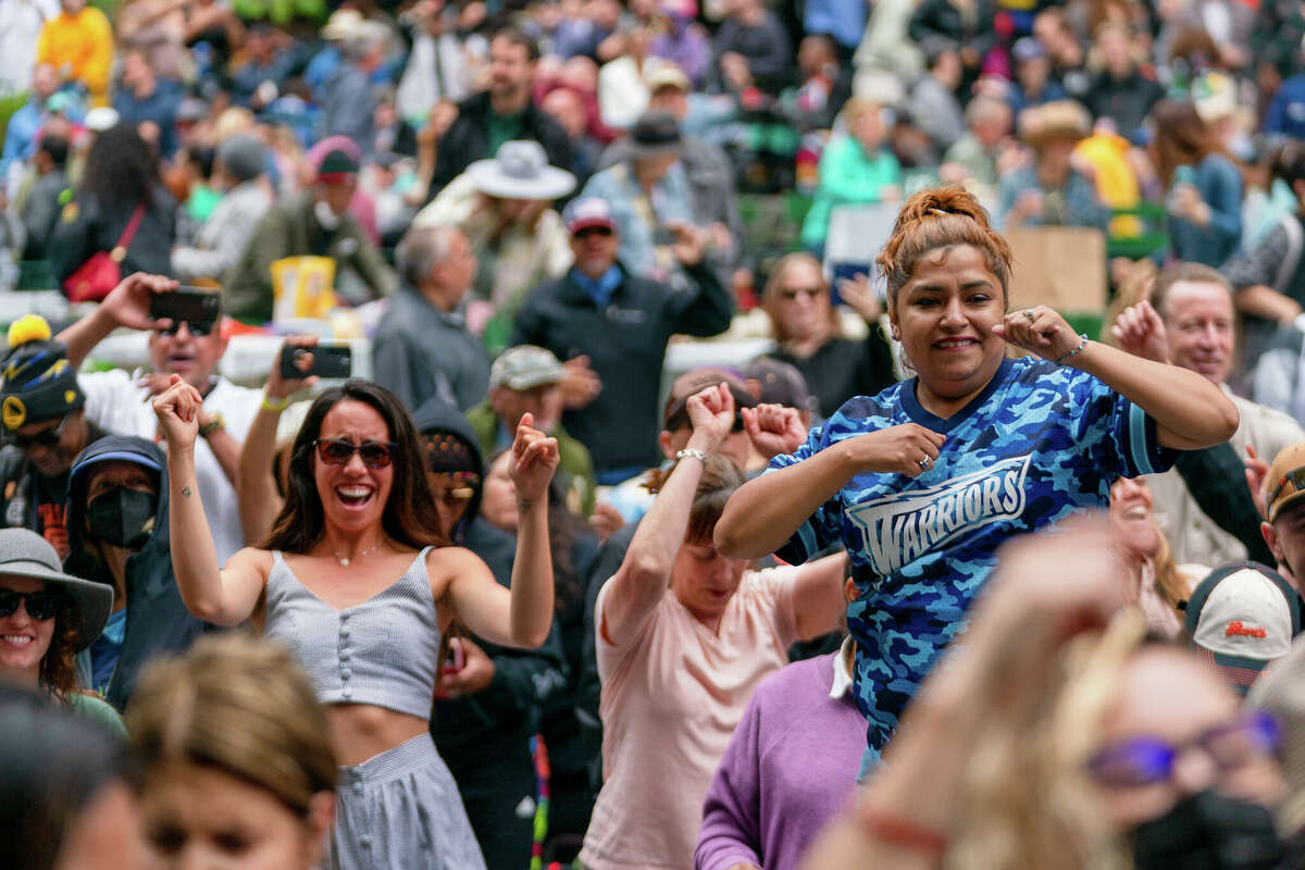 People dance while listening to Too $hort perform at the first concert of the year at the 85th Stern Grove Festival in San Francisco on Sunday, June 12, 2022.