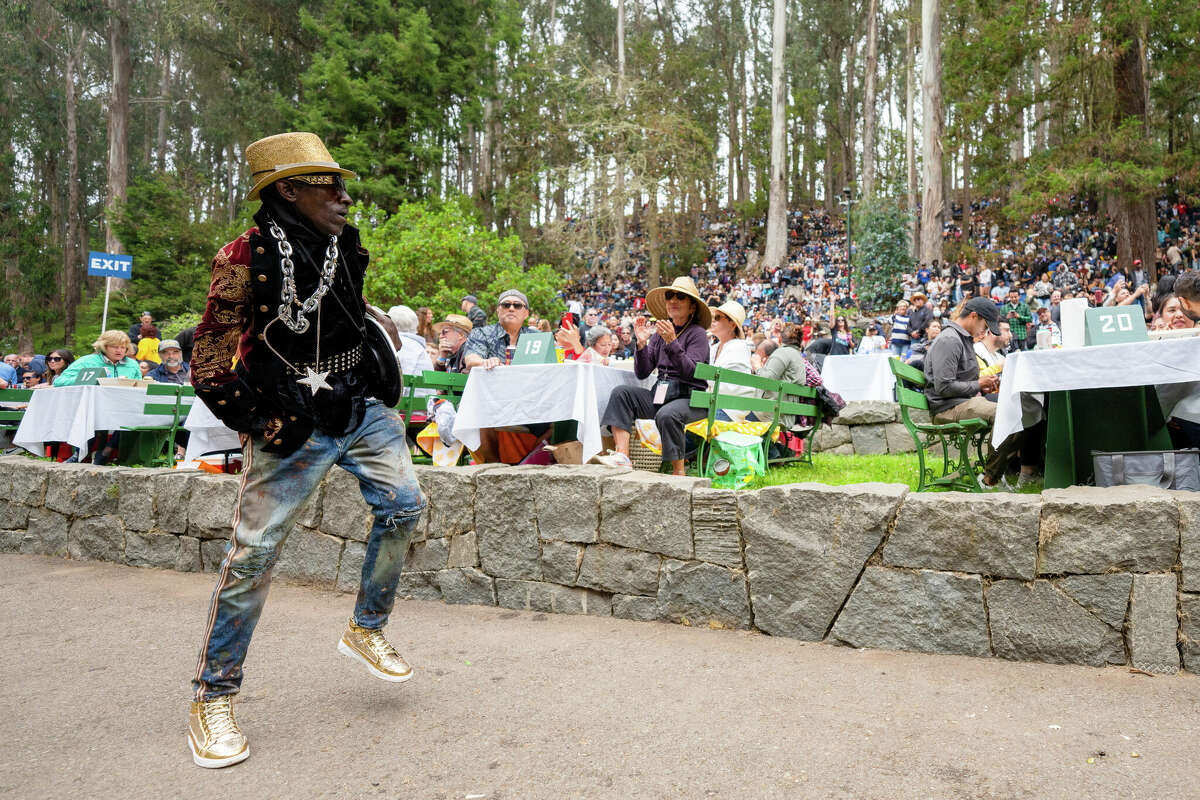 A man known as The Entertainer dances in the aisles while listening to Too $hort perform during the first concert of the year at the 85th Stern Grove Festival in San Francisco on Sunday, June 12, 2022. 