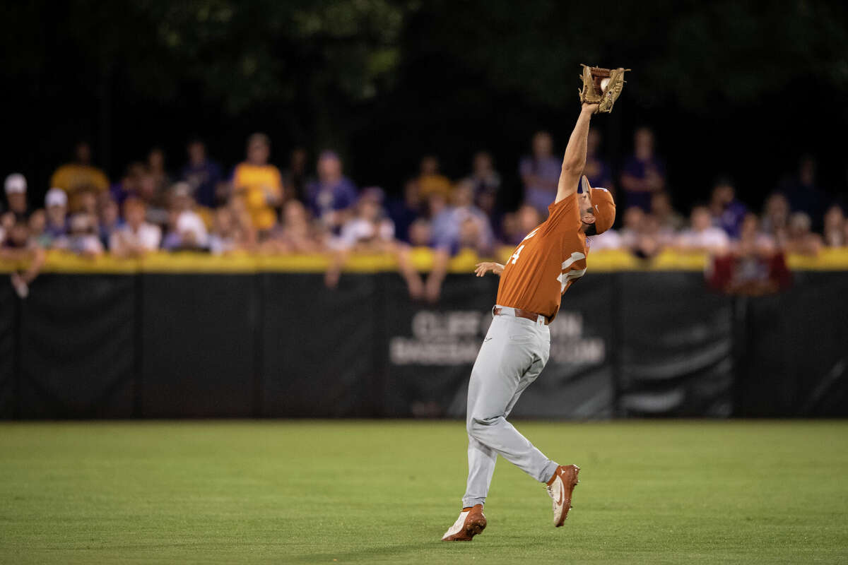 Texas' Murphy Stehly catches a fly ball hit by East Carolina's Jacob Starling during the second inning of an NCAA college super regional baseball game on Sunday, June 12, 2022, in Greenville, N.C. (AP Photo/Matt Kelley)