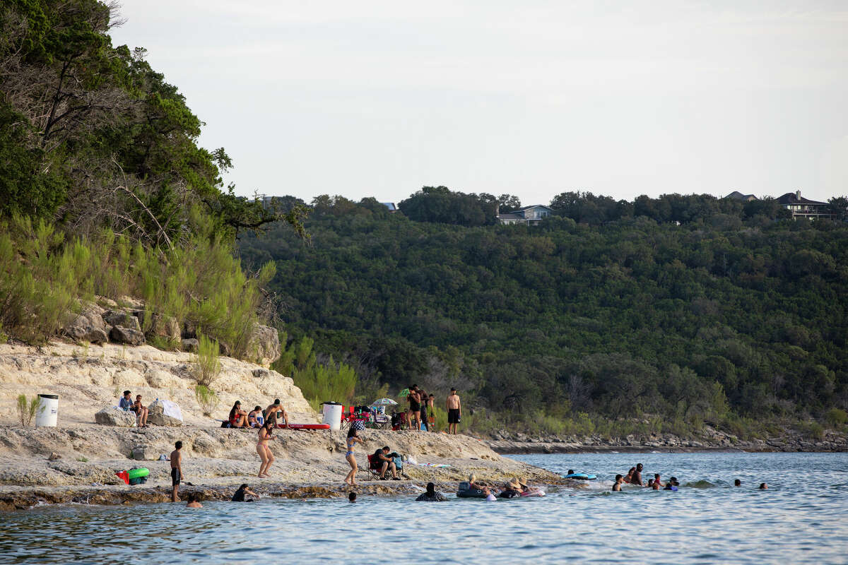 People congregate on the shore of Canyon Lake in Spring Branch, Texas, for Labor Day Weekend on Sunday, Sept. 6, 2020. 