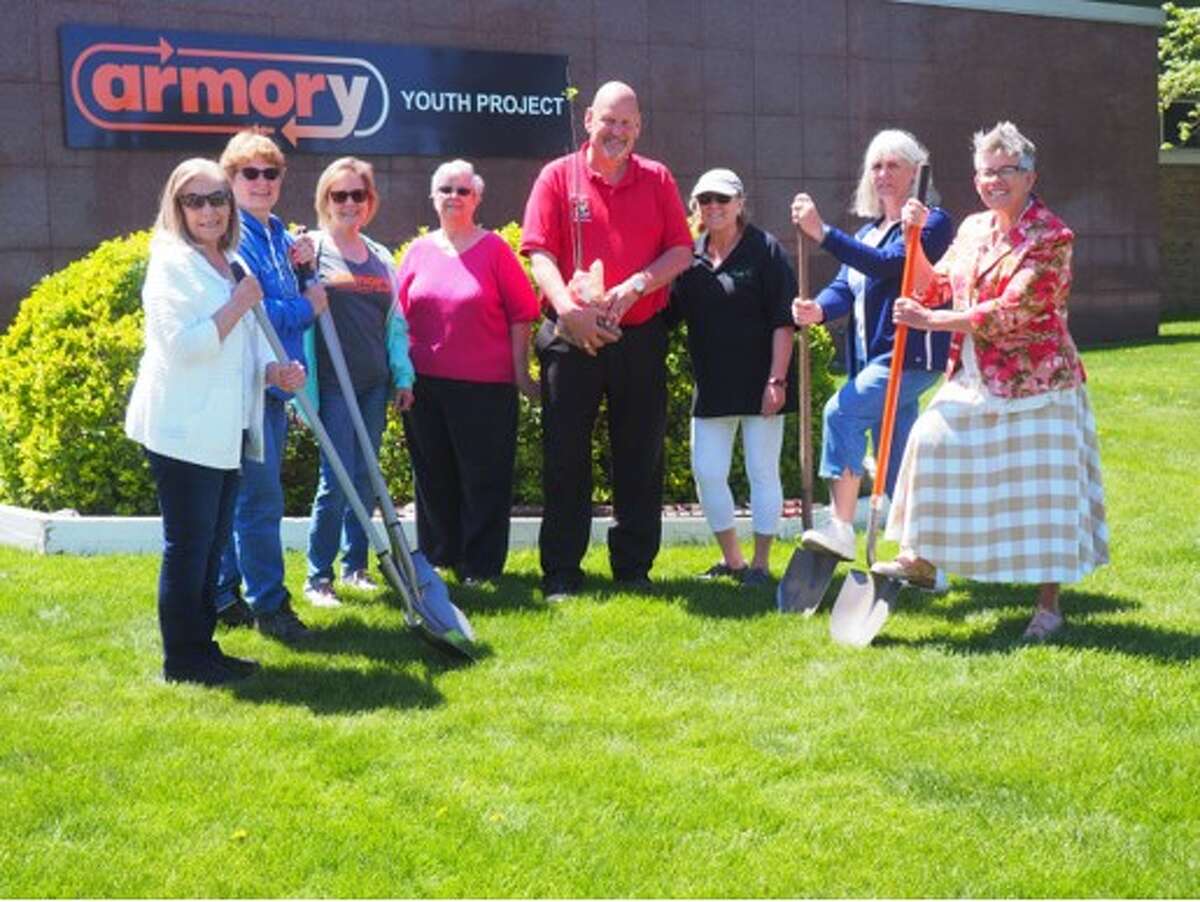 (From left) Barb Hadley, Beth Markowski, Armory Youth Project Executive Director Amy Wojciechowski, Mary Metzger, Sen. Curt VanderWall, Sandra Hosman, Lorraine Schwendner and Jill James show off the spot where seedlings from a 150-year-old street at the State Capitol will be planted.