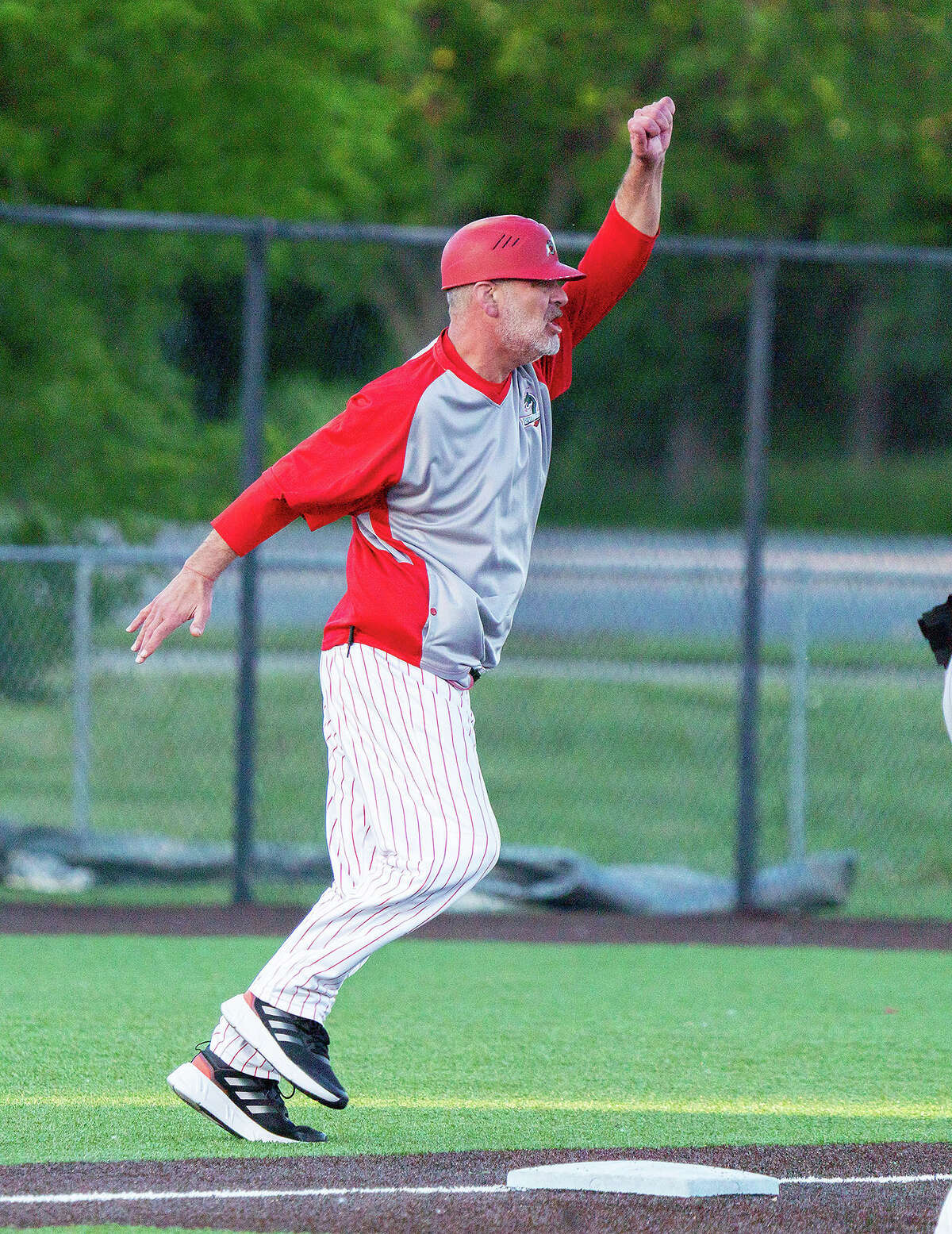 River Dragons manager Darrell Handelsman waves a runner around third during a game earlier this season.