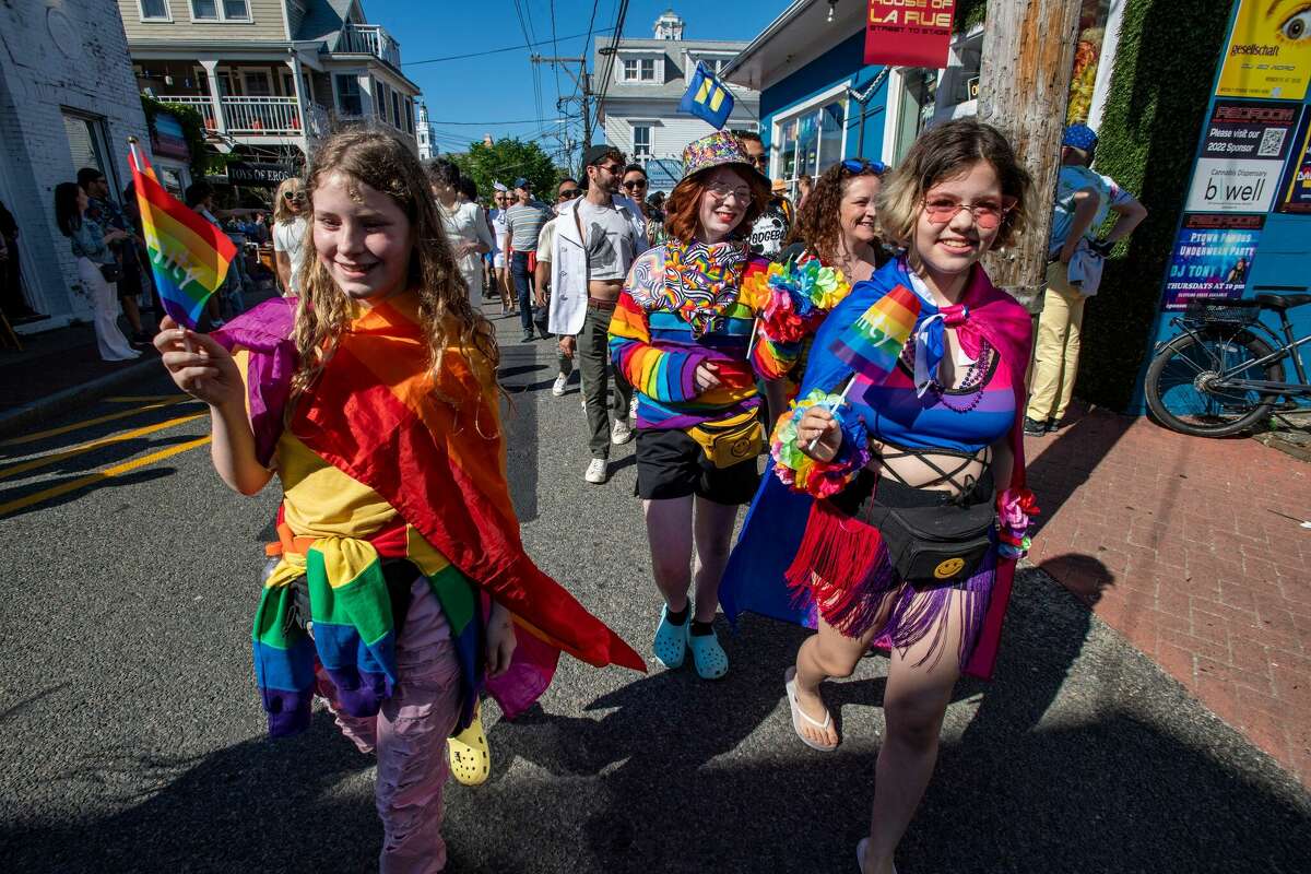 Attendees march to a club to dance at a tea party during a pride rally in Provincetown, Massachusetts, on June 4, 2022.