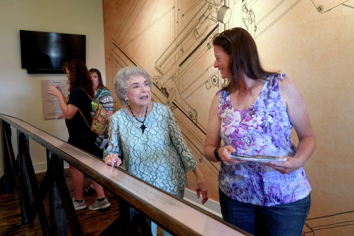 Beth Zipprich (left) talks with other guests as she takes in the Cawley exhibit opening at Spindletop Gladys City Boomtown Museum Saturday. Zipprich was a neighbor of the Cawley family. Photo made Saturday, June 11, 2022. Kim Brent/The Enterprise