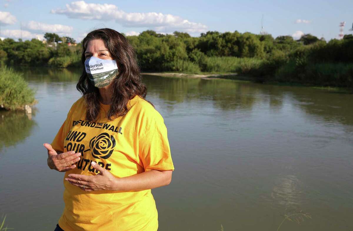 Melissa Cigarroa talks about border wall issues near the banks of the Rio Grande River in Laredo on Wednesday, Sept. 23, 2020. Cigarroa is part of the No Borderwall Laredo Coalition. Despite a vow to stop wall construction, the Biden administration is studying the environmental impact of a potential wall through Laredo, a first for the city.