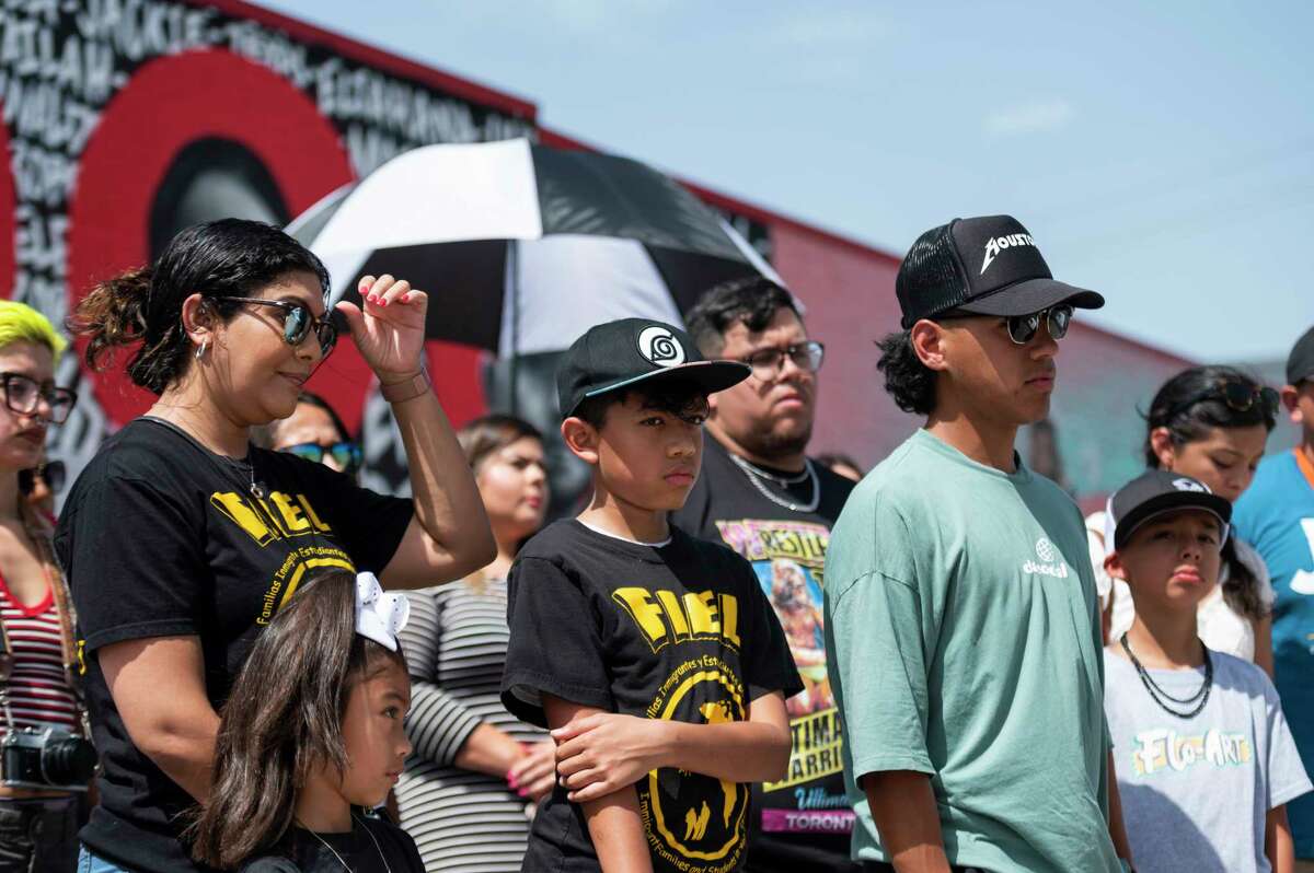 People stand and listen as FIEL’s Cesar Espinosa speaks at the unveiling of Floyd Mendoza’s mural for the victims of the Uvalde shooting Monday, June 13, 2022, in Pasadena, Texas.