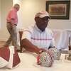 Former Ohio State running back Archie Griffin is in the midst of signing Ohio State helmets at the Walter Camp Football Foundation’s Ring of Honor Golf Classic at Race Brook Country Club in Orange on Monday.