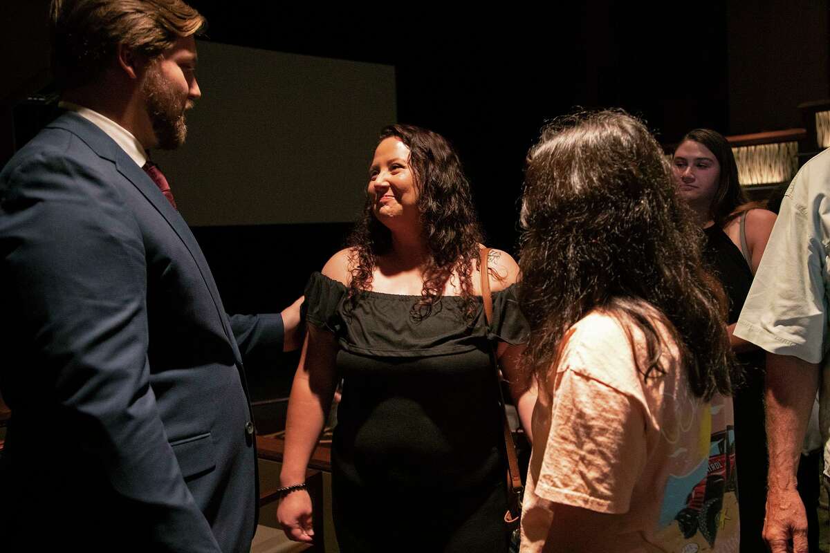 Jessica Ortiz, center, whose brother, David Angel Ortiz, was killed in a deliberately set fire at Iconic Village Apartments in San Marcos nearly four years ago, is joined by her daughter, Aalyiah Itzep, while talking with Brian Kyle “BK” Frizzell II at Texas State University of Sunday. Frizzell welcomed viewers to an advance screening of his documentary film, “The Weight of Ashes,” which focuses on the experiences of those who lost loved ones or were injured in the fire. The crime, which killed five people and severely burned another person, remains unsolved.