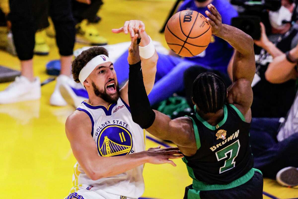 Golden State Warriors' Klay Thompson, 11, blocks a. Boston Celtics' Jaylen Brown, 7, shot during the third quarter in Game 5 of the NBA Finals at Chase Center in San Francisco, Calif., on Monday, June 13, 2022.