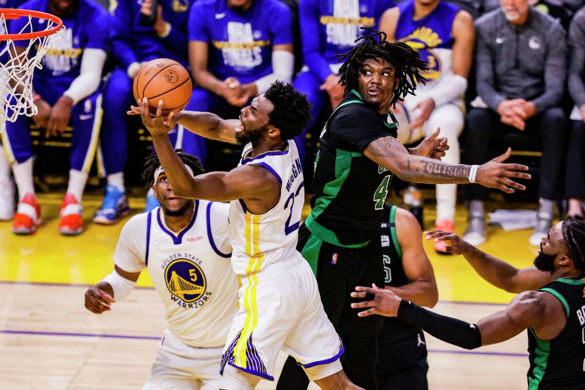 Golden State Warriors' Andrew Wiggins, 22, goes in for a layup past Boston Celtics' Robert Williams III, 44, during the fourth quarter in Game 5 of the NBA Finals at Chase Center in San Francisco, Calif., on Monday, June 13, 2022.