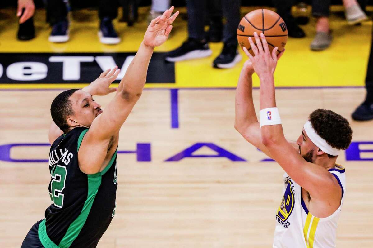 Golden State Warriors' Klay Thompson, 11, shoots a three pointer over Boston Celtics' Al Horford, 42, during the third quarter in Game 5 of the NBA Finals at Chase Center in San Francisco, Calif., on Monday, June 13, 2022.
