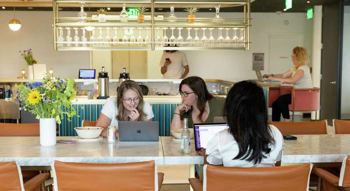 Expensify employees Shaelyn Combs (left), Gabi Horowitz, Anu Muralidharan and Niki Wallroth work at the San Francisco Expensify Lounge. Invited guests as well as employees of the expense management software company can work out of the downtown space.