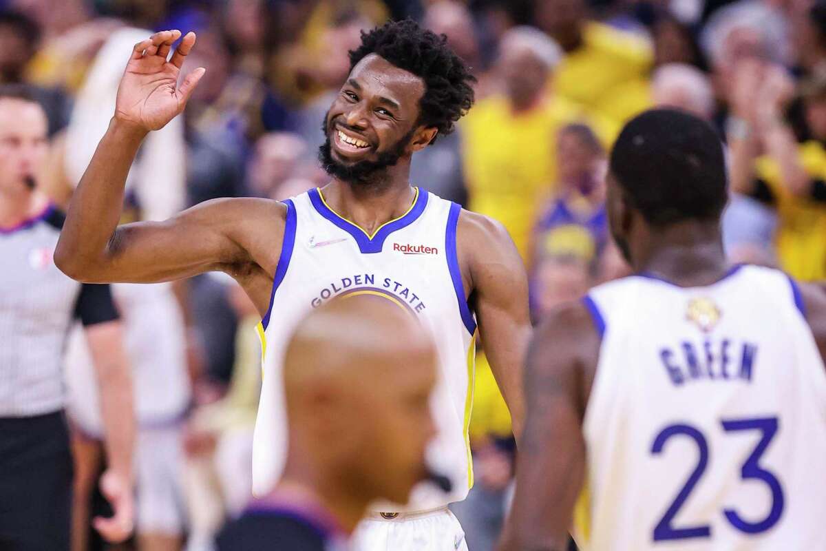 Golden State Warriors' Andrew Wiggins, 22, reacts to Draymond Green, 23, during the second quarter in Game 5 of the NBA Finals at Chase Center in San Francisco, Calif., on Monday, June 13, 2022.