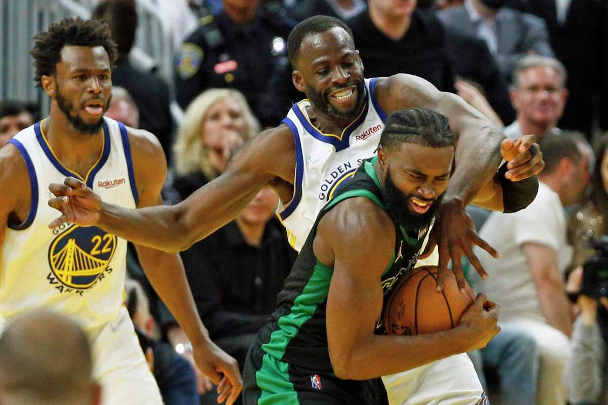 Golden State Warriors forward Draymond Green (23) defends Boston Celtics guard Jaylen Brown (7) during the fourth quarter in Game 5 of the NBA Finals at Chase Center, Monday, June 13, 2022, in San Francisco, Calif.