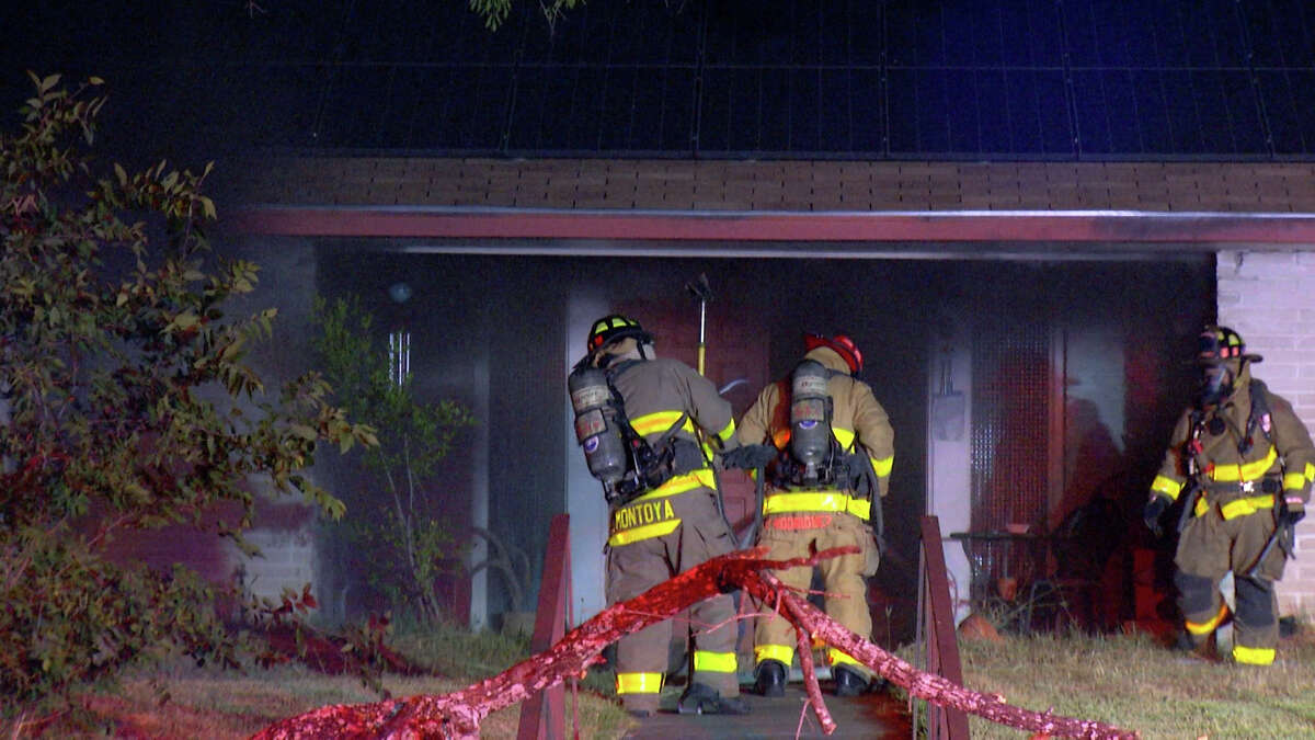 San Antonio firefighters arrived to find flames shooting out the back of the home Tuesday.