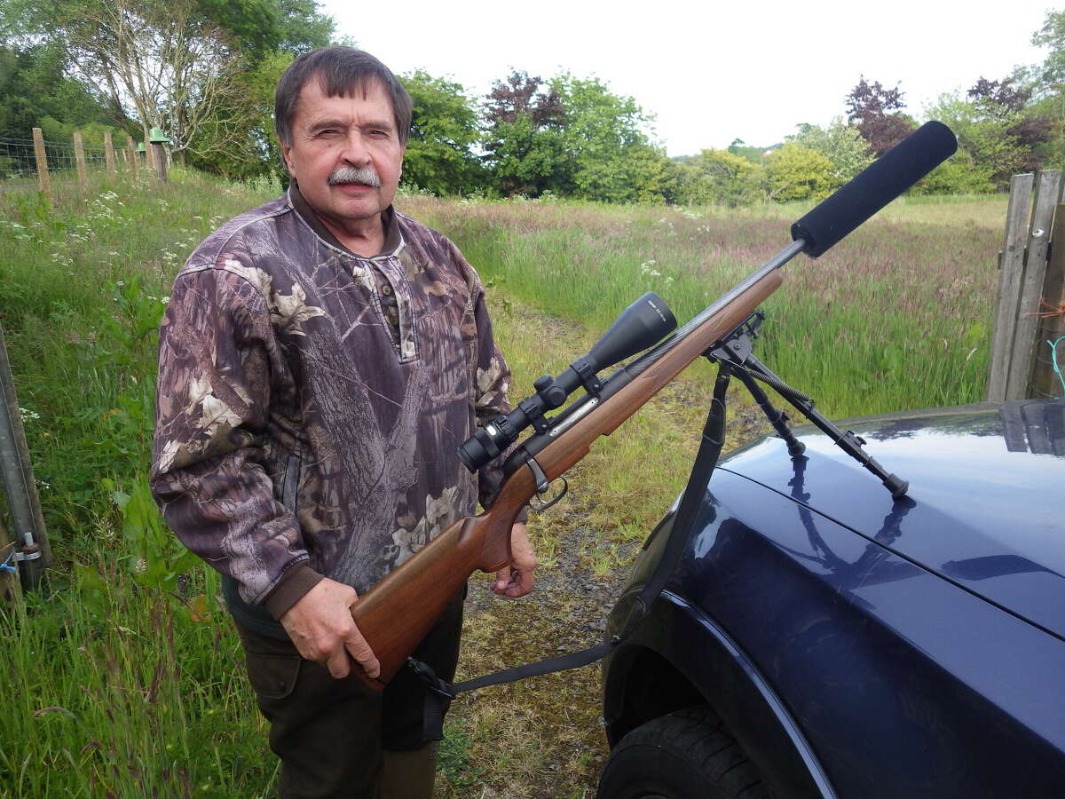 Michael Grosse of International Adventures holds the rifle that Tom Lounsbury would use to shoot a mature roebuck at 281 yards. Silencers are allowed for hunting in the United Kingdom.