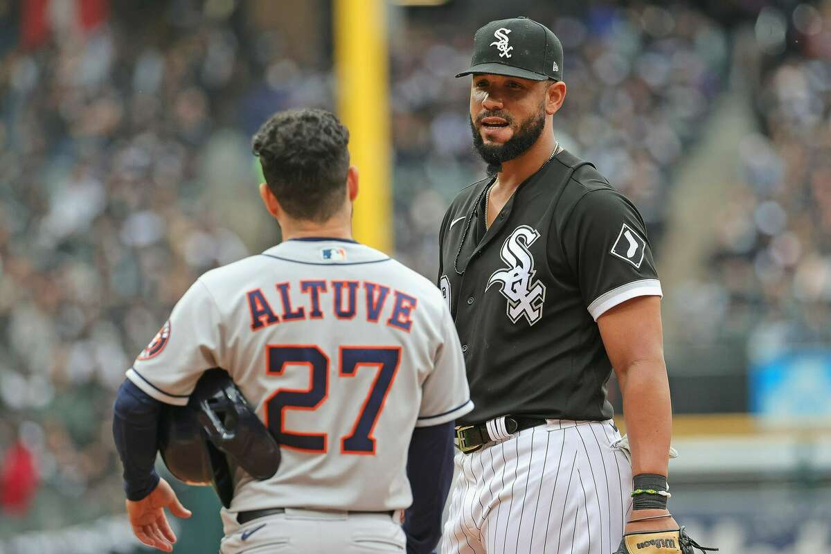 Jose Abreu of the Chicago White Sox talks with Jose Altuve of the Houston Astros during a pitching change of Game 4 of the 2021 American League Division Series at Guaranteed Rate Field on October 12, 2021 in Chicago, Illinois.