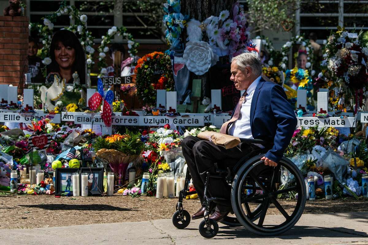 Texas Governor Greg Abbott arrives while US President Joe Biden and First Lady Jill Biden pay their respects at a makeshift memorial outside of Robb Elementary School in Uvalde, Texas on May 29, 2022. 