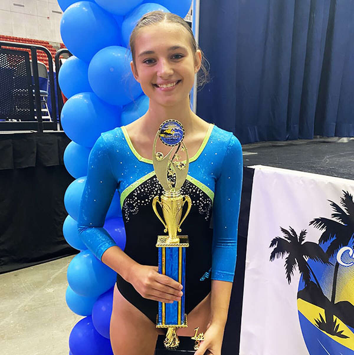 Allison Jennings of Mid-Illinois Gymnastics in Godfrey with the  National Tumbling Advanced championship trophy she won Tuesday at the USTA Nationals in Lakeland, Fla. Jenkins, 14, will be a sophomore at Edwardsville High School this fall. 
