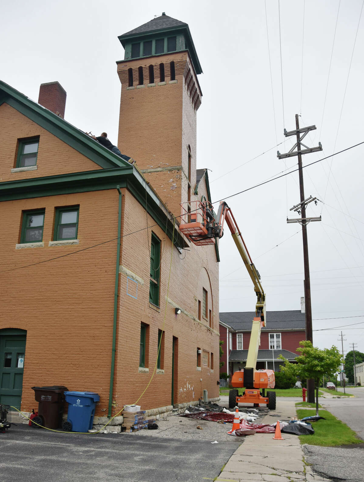 An Ostrander Windows, Siding & Roofing crew could be seen at work on the Manistee City Fire Department roof on Tuesday. 
