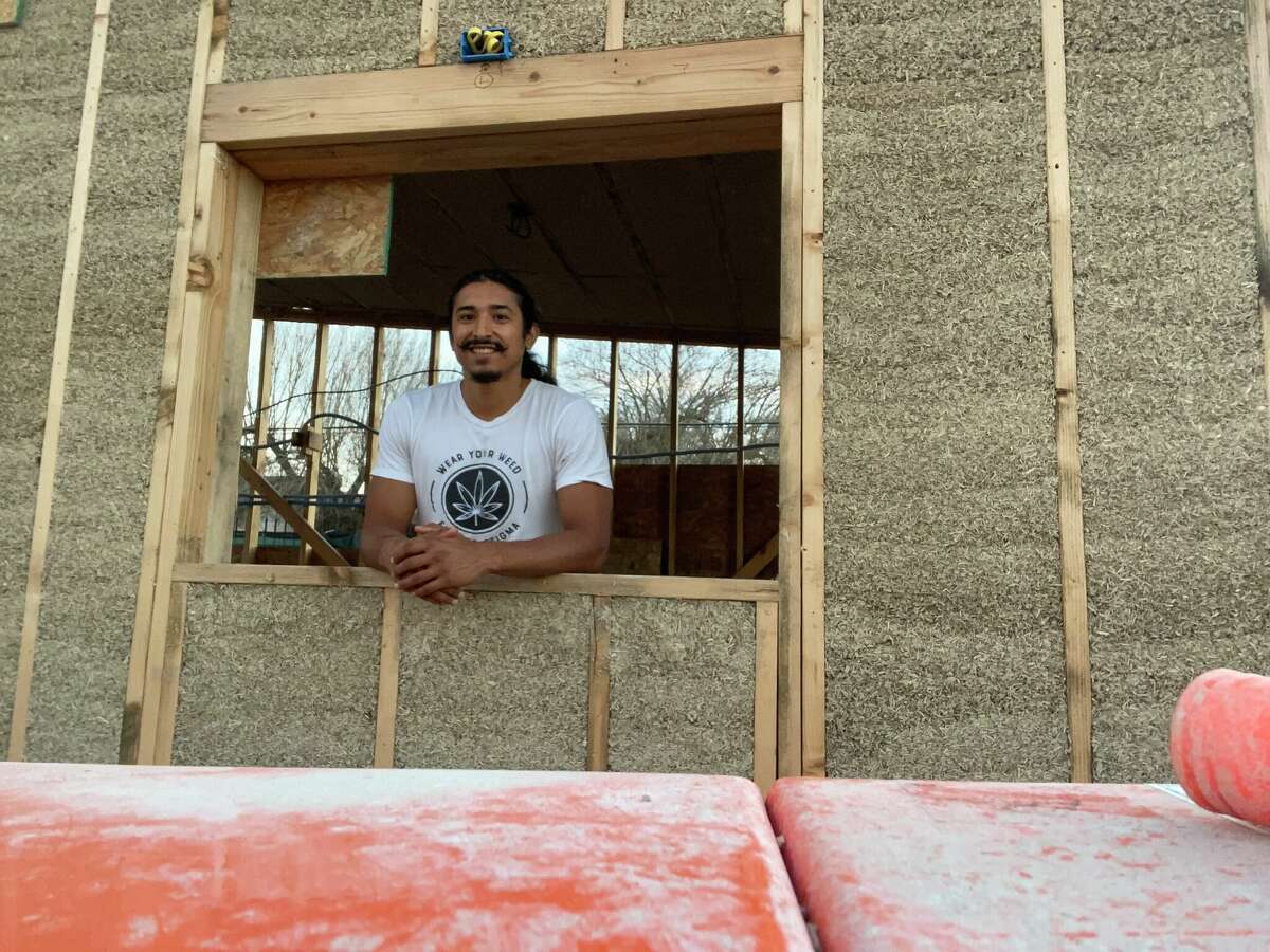 Amos Lozano standing in the midst of his hempcrete-build cannabis juice shop. 