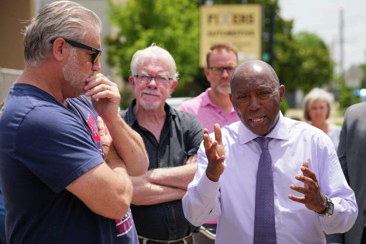 Mayor Sylvester Turner talks to Shane Stinson, left, as he speaks with Heights area residents while taking a closer look at 11th Street, after plans to change traffic patterns on the street, including adding a bicycle lane, that drew some alarm from residents Wednesday, May 25, 2022 in Houston. Area residents near 11th fear taking away a lane for vehicles will create traffic problems, which will spill onto residential streets nearby. They argue minimal changes can achieve the same safety benefits.