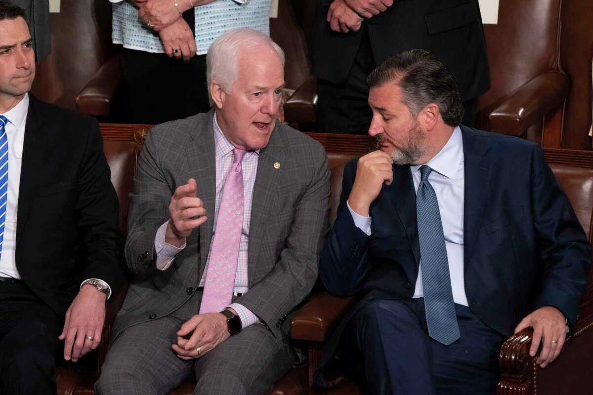 Sen. John Cornyn, R-Texas, center, and Sen. Ted Cruz, R-Texas, right, speak together, joined at far left by Sen. Tom Cotton, R-Ark., in the House chamber as they await a speech by the Greek prime minister, at the Capitol in Washington, May 17, 2022.
