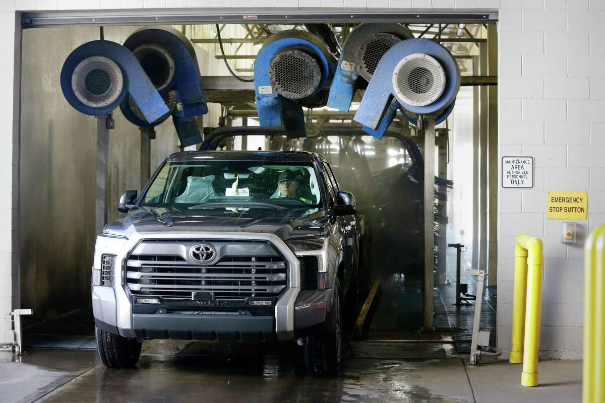 Toyota Tundra trucks go through a car wash before they begin the final processing to then ship to dealerships at the Friedkin Group Gulf States Toyota processing facility Thursday, May 26, 2022 in Houston, TX.