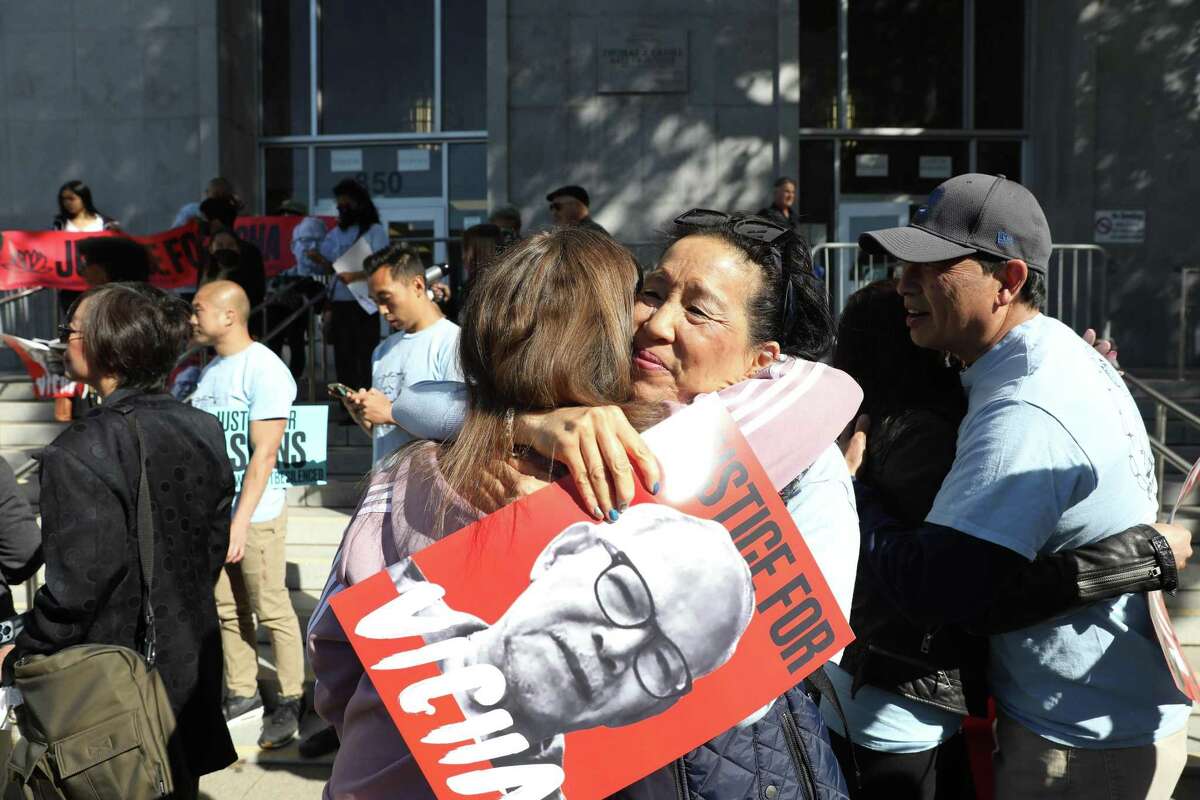 Vanita Louie (right) hugs Paulina Fayer of Activ8sf at a rally for the family of Vicha Ratanapakdee at the Hall of Justice.