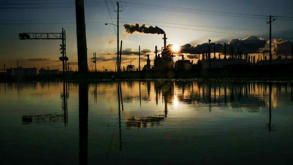 The sun sets behind the LyondellBasell Houston Refinery, one of the businesses on the list of high harm facilities, Thursday, April 14, 2016 in Houston.