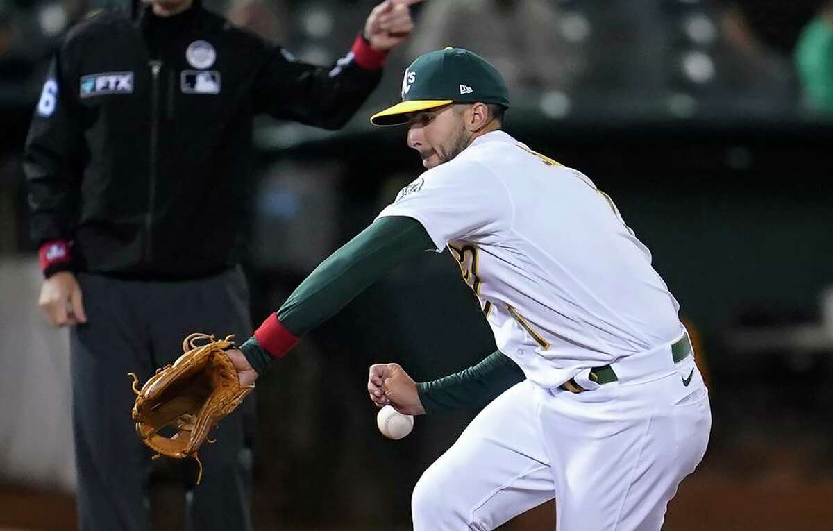 Oakland Athletics third baseman Kevin Smith cannot field a base hit by Boston Red Sox's Trevor Story during the eighth inning of a baseball game in Oakland, Calif., Friday, June 3, 2022. (AP Photo/Jeff Chiu)