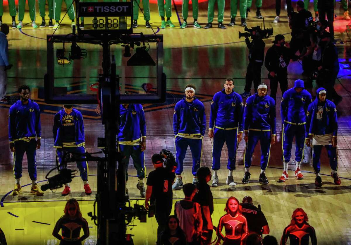 Klay Thompson (center) and his teammates listen during the pledge of allegiance ahead of Game 5 of the NBA Finals between the Golden State Warriors and the Boston Celtics on Monday, June 13, 2022 in San Francisco, California. Golden State Warriors defeated the Boston Celtics 104-94.
