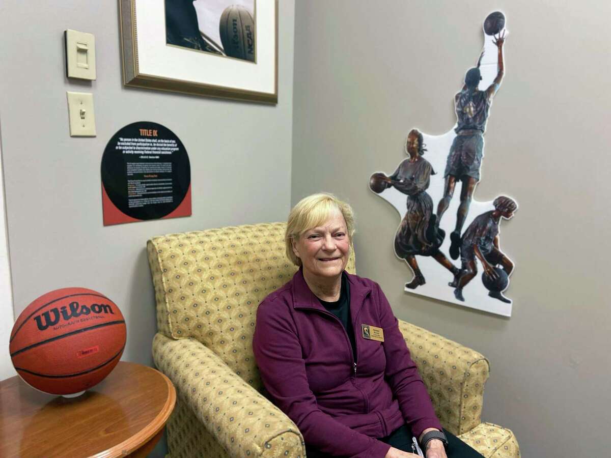 Debbie Ryan poses at the Women's Basketball Hall of Fame in Knoxville, Tenn., Saturday, June 11, 2022. Marsha Sharp, Ann Meyers Drysdale, Debbie Ryan and others all worked their way through the nascent days of Title IX to the heights of women’s basketball. (AP Photo/Teresa Walker)