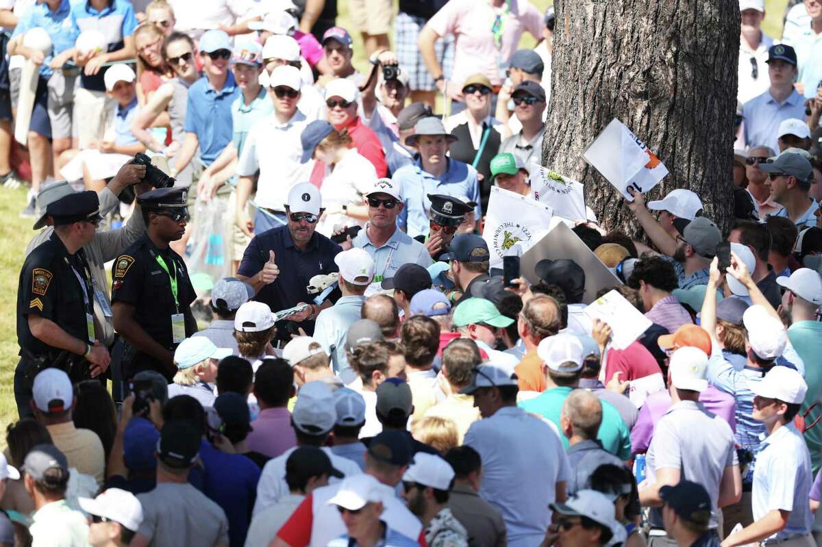 BROOKLINE, MASSACHUSETTS - JUNE 14: Phil Mickelson of the United States gives a thumbs up as he signs his autograph for fans near the ninth hole during a practice round prior to the US Open at The Country Club on June 14, 2022 in Brookline, Massachusetts. (Photo by Rob Carr/Getty Images)