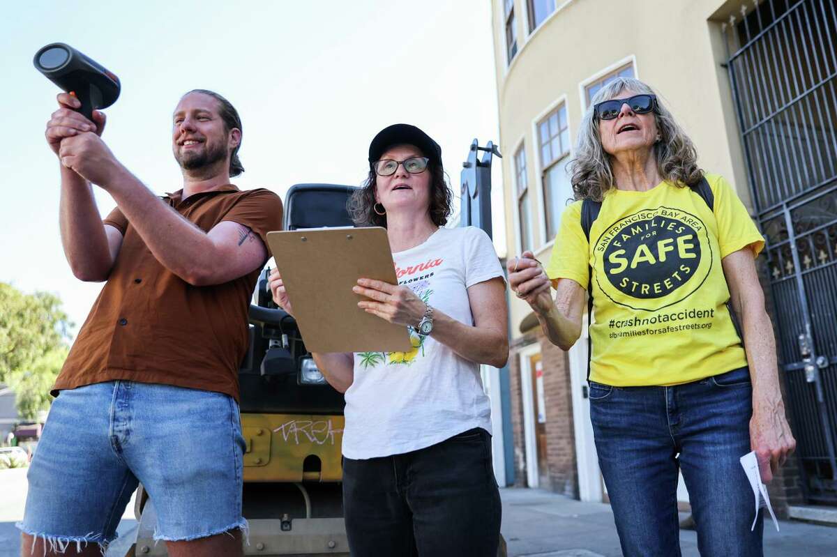 Stan Parkford (left), Annie Franklin and Nancy Harrison-Noonan collect data on car speeding in the streets. Harrison-Noonan was badly injured when she was struck by a car in 2019.