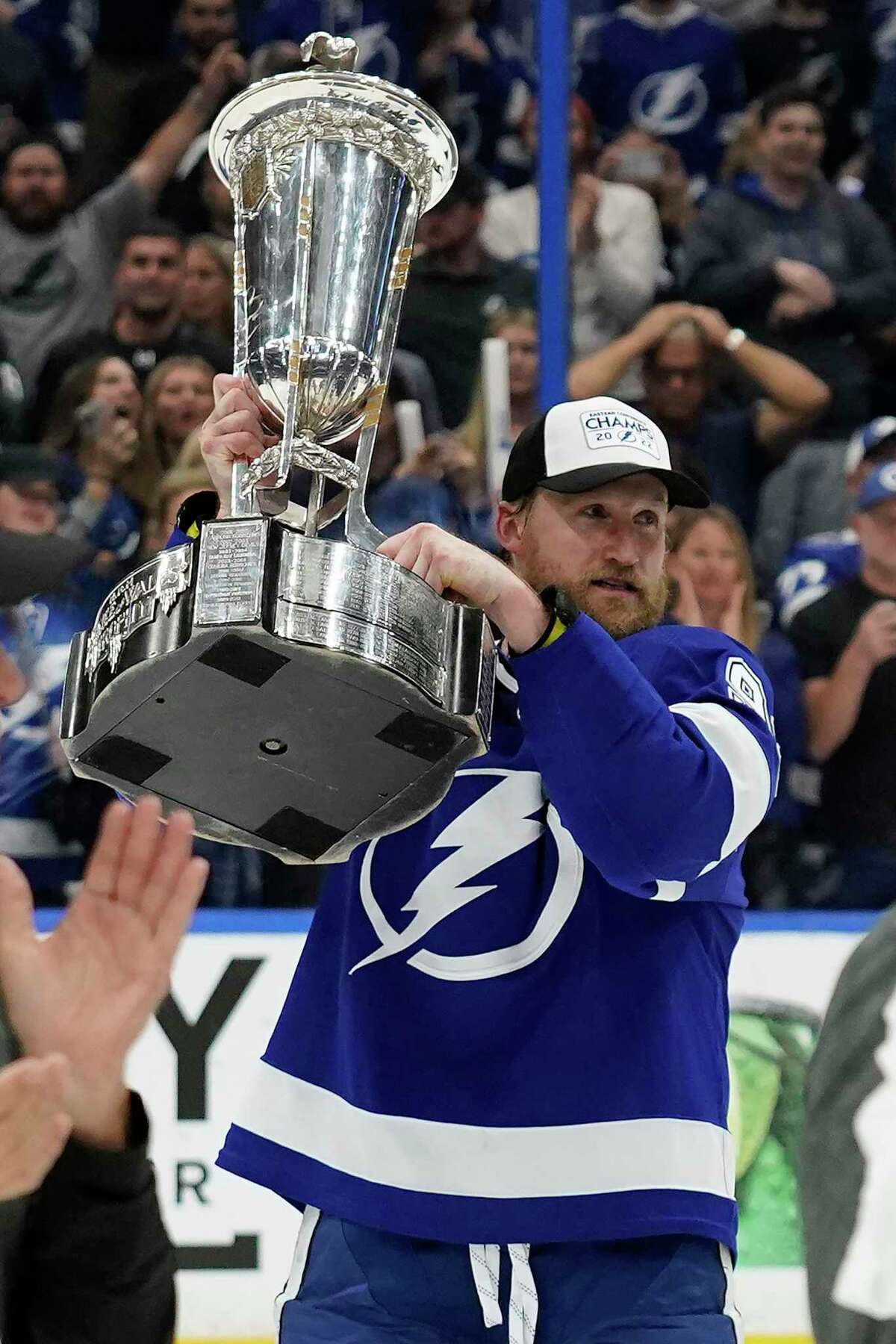 Tampa Bay Lightning center Steven Stamkos (91) holds up the Prince of Wales trophy after the team defeated the New York Rangers during Game 6 of the NHL hockey Stanley Cup playoffs Eastern Conference finals Saturday, June 11, 2022, in Tampa, Fla. The Lightning advanced to the Stanley Cup Finals. (AP Photo/Chris O'Meara)