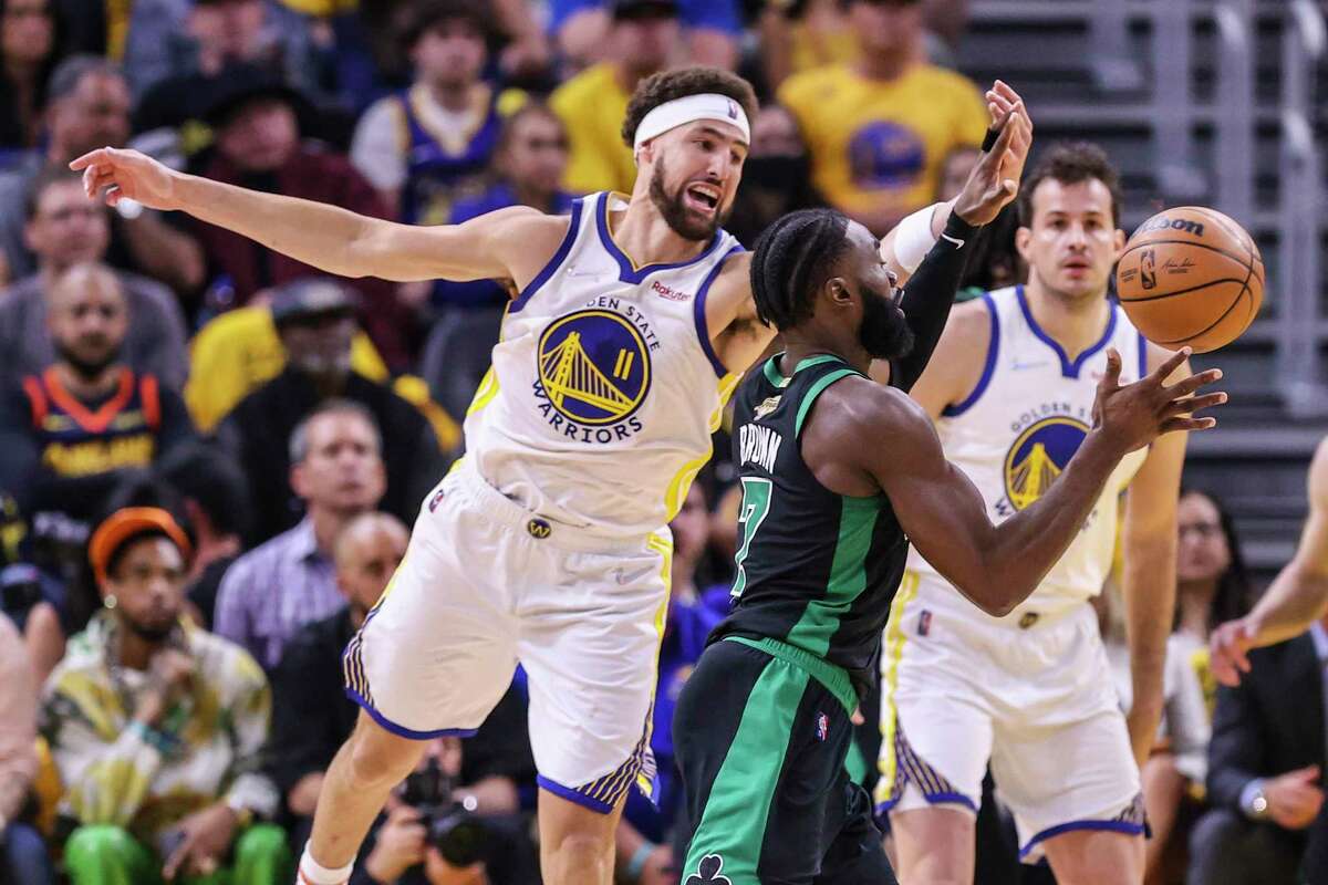 Golden State Warriors' Klay Thompson, 11, defends against Boston Celtics' Jaylen Brown, 7, during the second quarter in Game 5 of the NBA Finals at Chase Center in San Francisco, Calif., on Monday, June 13, 2022.