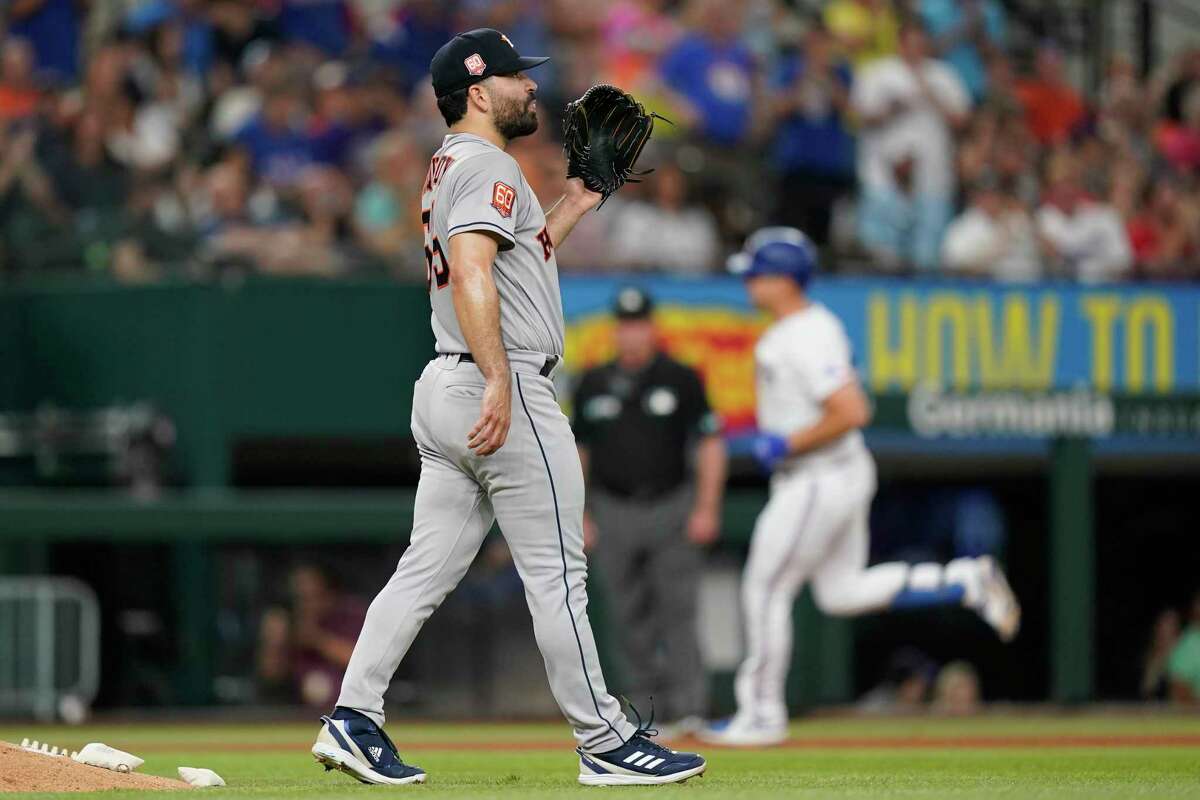 Houston Astros starting pitcher Jose Urquidy (65) waits for a new ball as Texas Rangers' Nathaniel Lowe, right, runs the bases after hitting a two-run home run during the fourth inning of a baseball game in Arlington, Texas, Tuesday, June 14, 2022. (AP Photo/LM Otero)