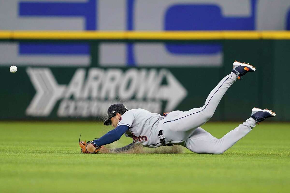 Houston Astros shortstop Jeremy Pena dives but is unable to reach a single by Texas Rangers' Corey Seager in the third inning of a baseball game, Monday, June 13, 2022, in Arlington, Texas. (AP Photo/Tony Gutierrez)