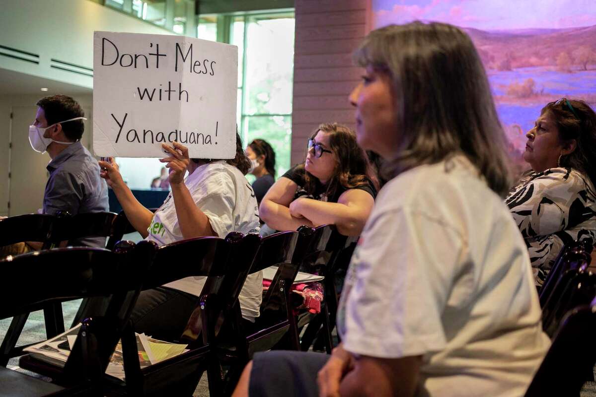 Alesia Garlock holds a sign that reads “Don’t mess with Yanaguana!” during the fourth public meeting regarding the Brackenridge Park Project at the Witte Museum on June 14.