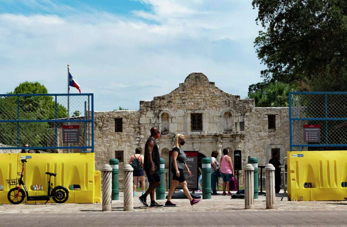 Visitors walk the Alamo grounds and church in this Sept. 17, 2020, photo.