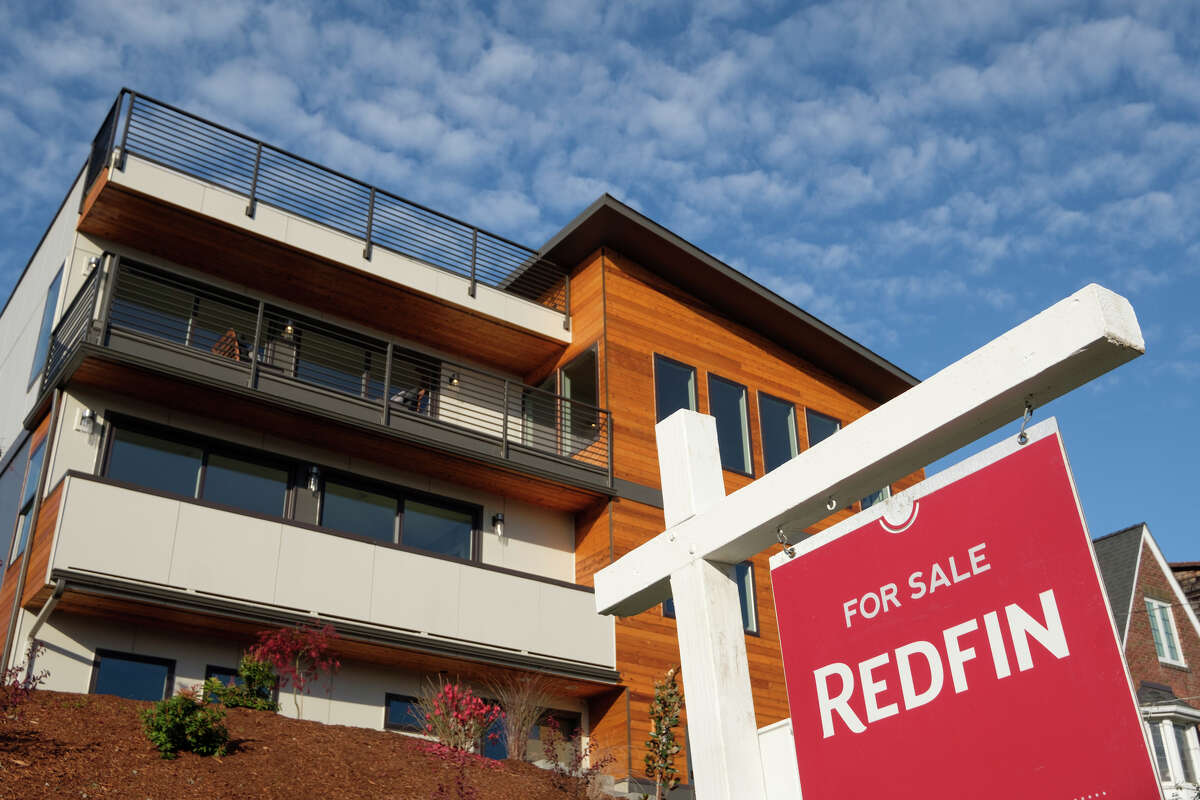 FILE: A Redfin real estate yard sign is pictured in front of a house for sale on October 31, 2017 in Seattle, Washington. Photo by Stephen Brashear/Getty Images for Redfin